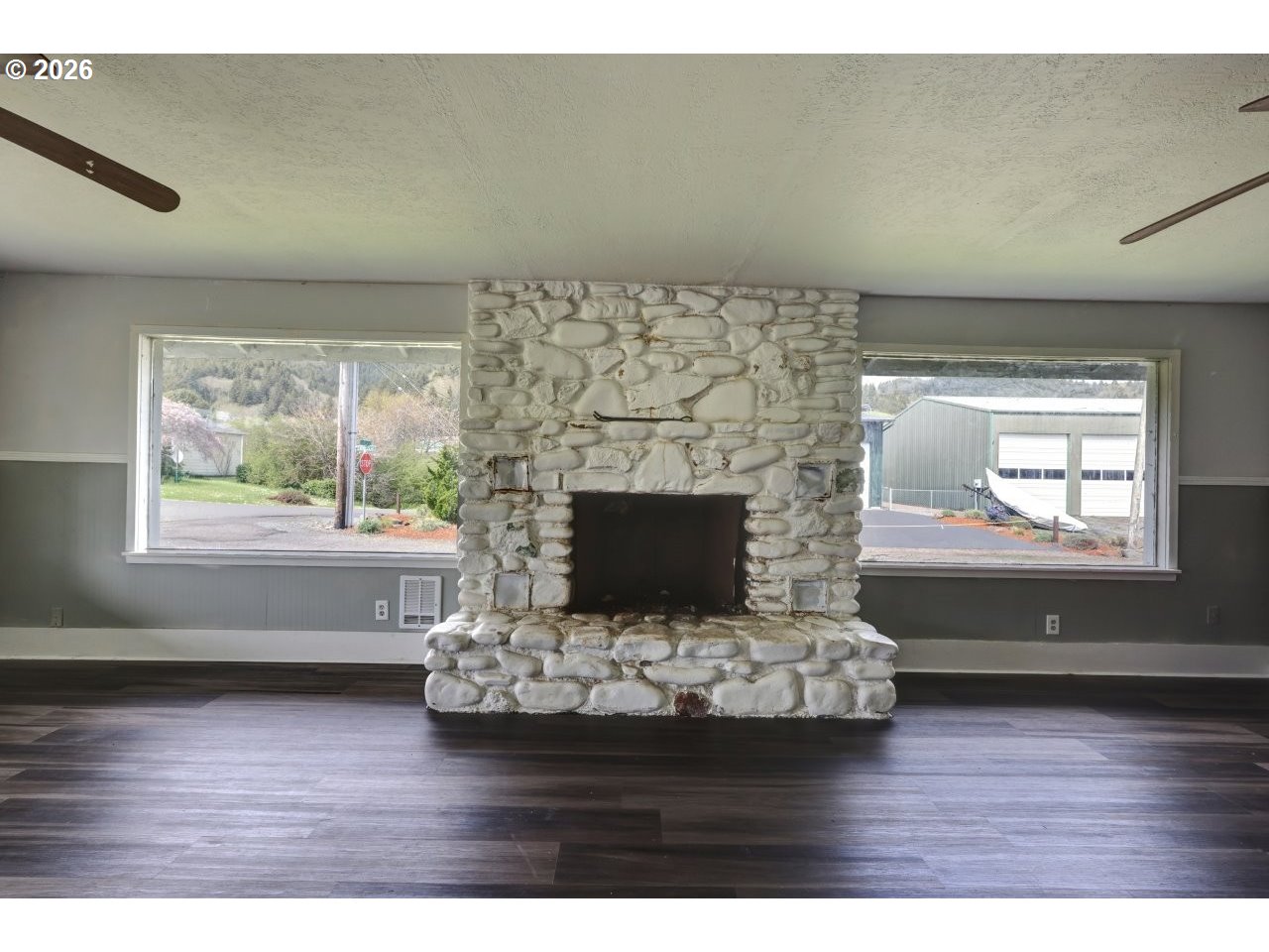 308 1st Street Garibaldi, OR 97118 - Photo 7 of 48 a living room with a fireplace and wooden floor