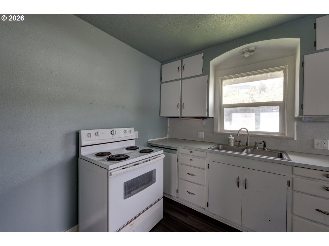 308 1st Street Garibaldi, OR 97118 - Photo 9 of 48 a kitchen with cabinets appliances a sink and a window