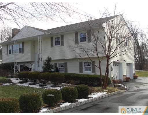 1107 New Dover Road Edison, NJ 08820 - Photo 1 of 10 a front view of a house with a garden