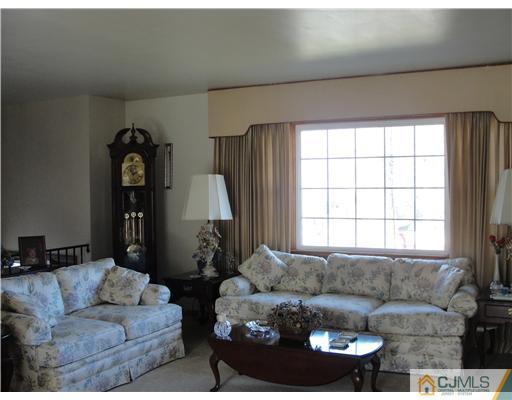 1107 New Dover Road Edison, NJ 08820 - Photo 2 of 10 a living room with furniture and a window