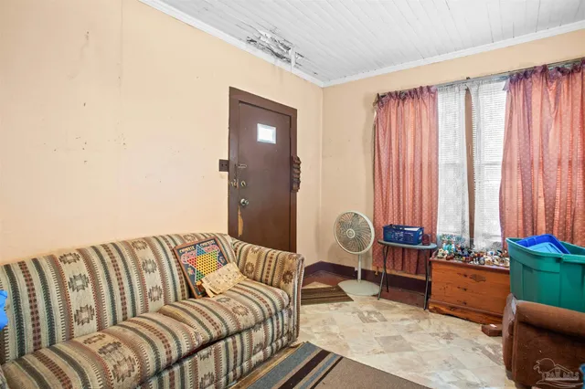 a bedroom with furniture and a large window