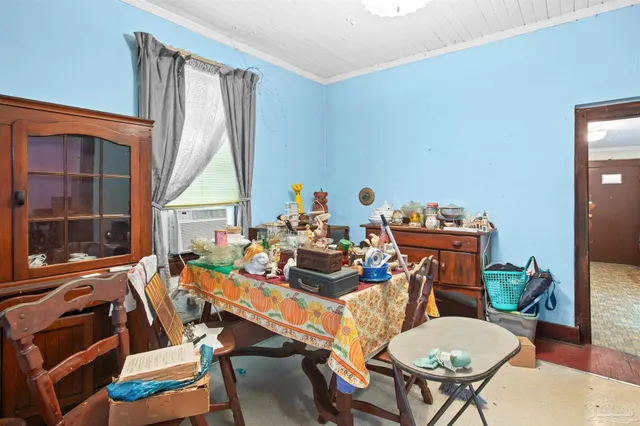 a dining room with furniture a rug and wooden floor