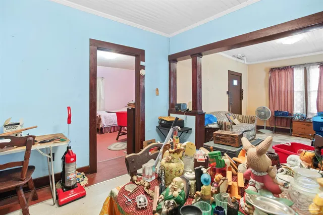 a living room filled with furniture and a large window