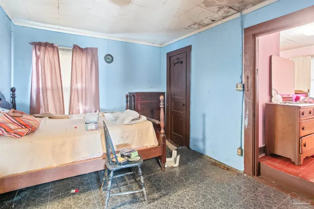 a bedroom with a bed and a dresser