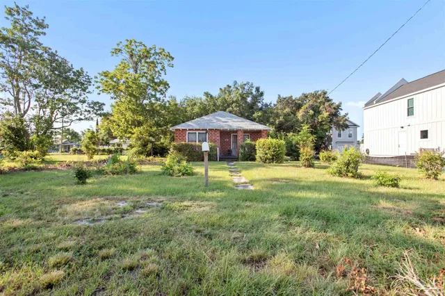 a swimming pool with outdoor seating and yard