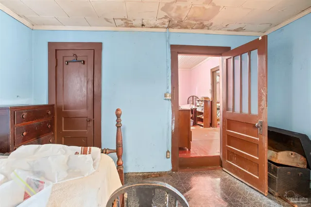 a bedroom with bed and a window