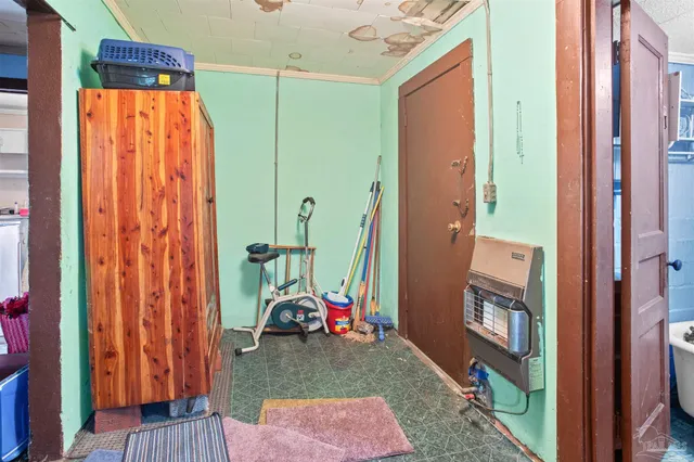 a bedroom with a bed a dresser and chair