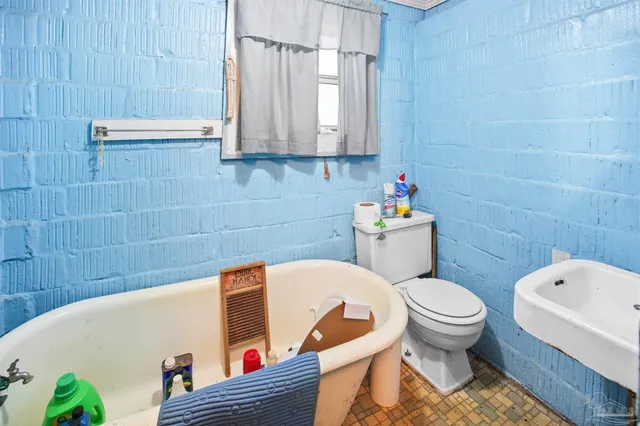 a living room with closet flat screen tv and rug