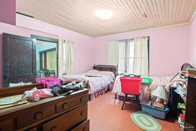 a view of a patio with a table and chairs and potted plants
