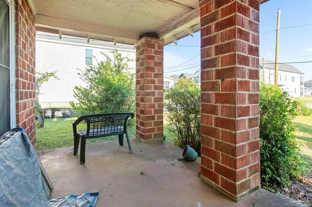 a view of a chairs and a table in the patio