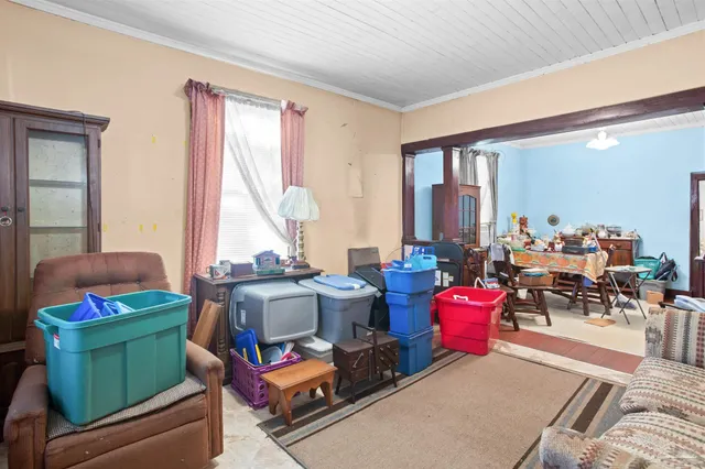 a room with furniture toys and a large window
