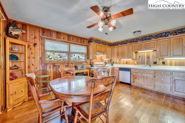 a dining room filled a chandelier fan and a table
