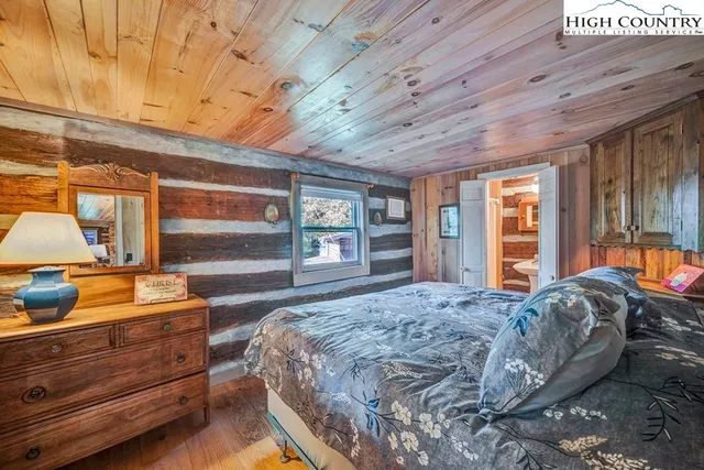 a spacious bedroom with a large bed and large windows