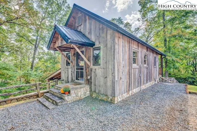 a view of a house with backyard and deck