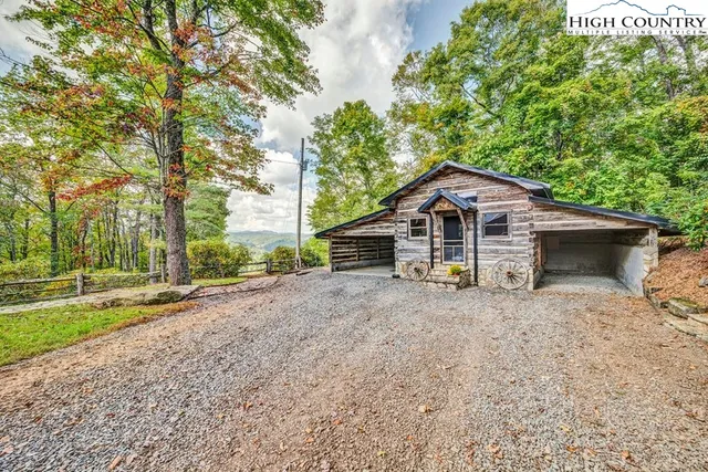 a dirt road with trees in the background