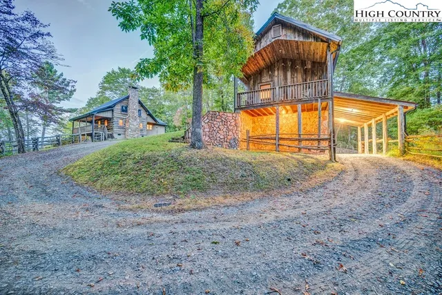 a view of backyard with large trees and plants