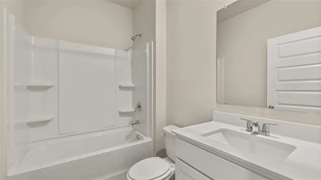a bathroom with a granite countertop sink toilet tub and shower