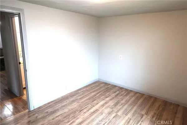 a view of a hallway with wooden floor windows and livingroom