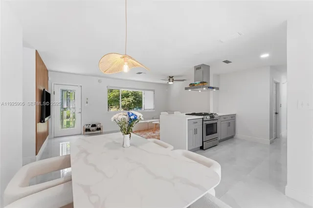 a very nice looking room with a large window and stainless steel appliances