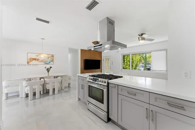a living room with furniture a flat screen tv and a large window