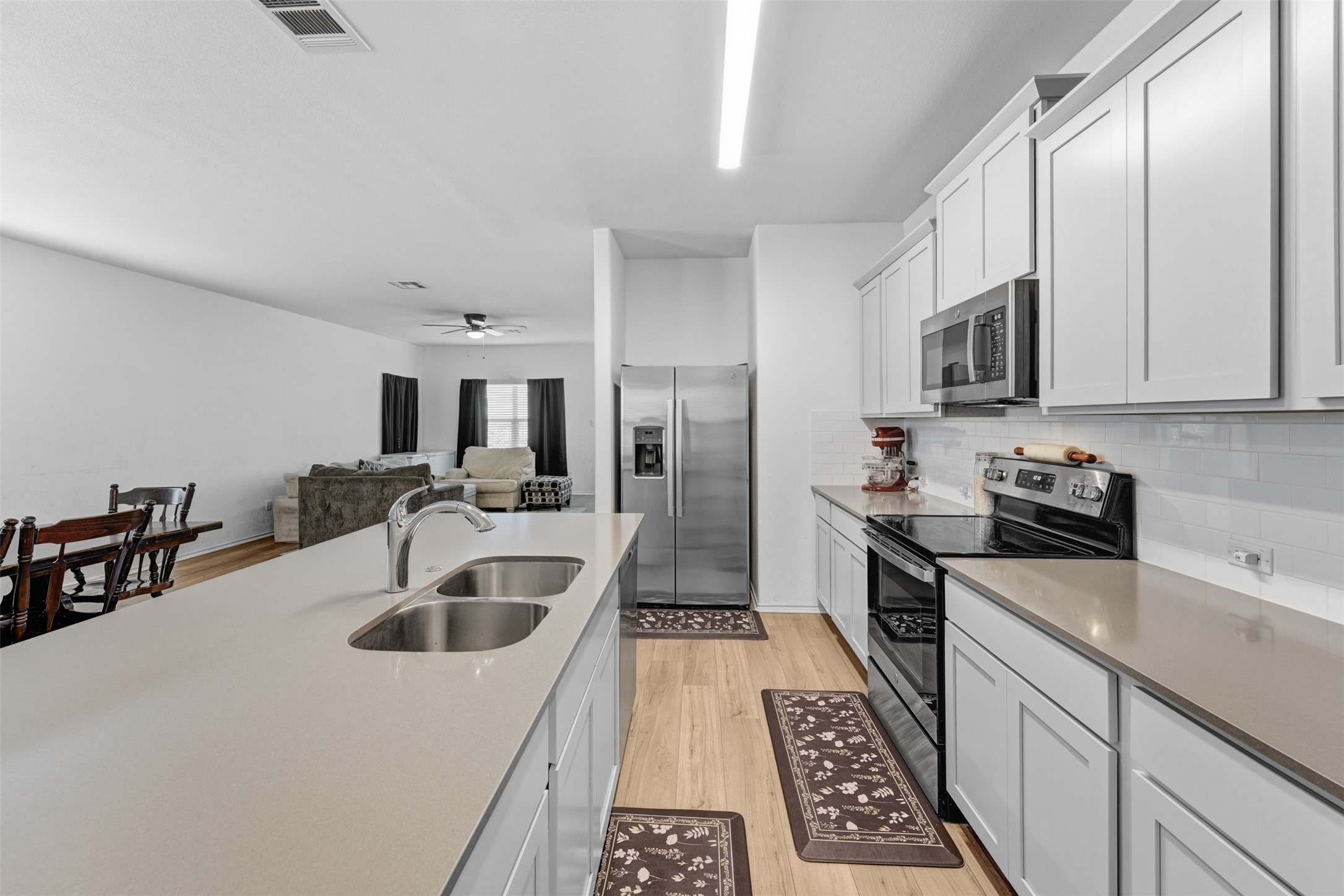 413 Perfect World Loop Jarrell, TX 76537 - Photo 12 of 39 A well-lit kitchen with sleek countertops and modern appliances offers an ideal setting for culinary creativity.