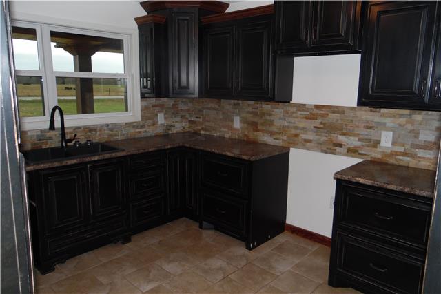 491 Rabbit Trail Road Leoma, TN 38468 - Photo 4 of 19 a kitchen with granite countertop a sink and a stove