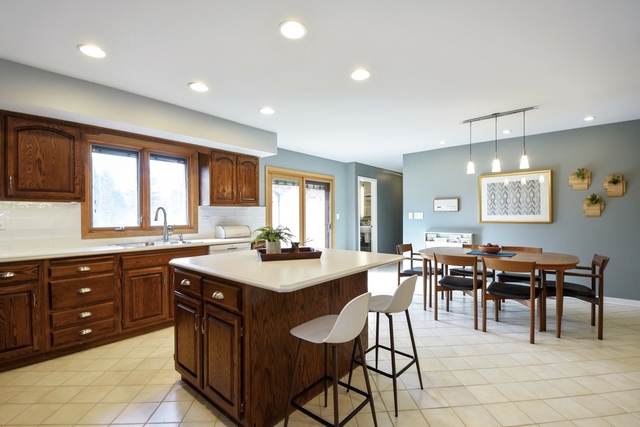 2120 Applecross Road Inverness, IL 60010 - Photo 11 of 38 a large kitchen with lots of furniture a sink appliances and dining table