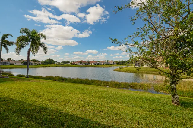 a view of a lake with houses in the back