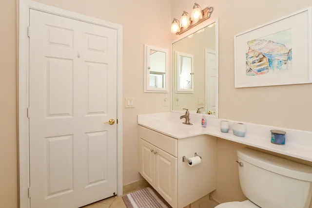 a living room with furniture a flat screen tv and a window