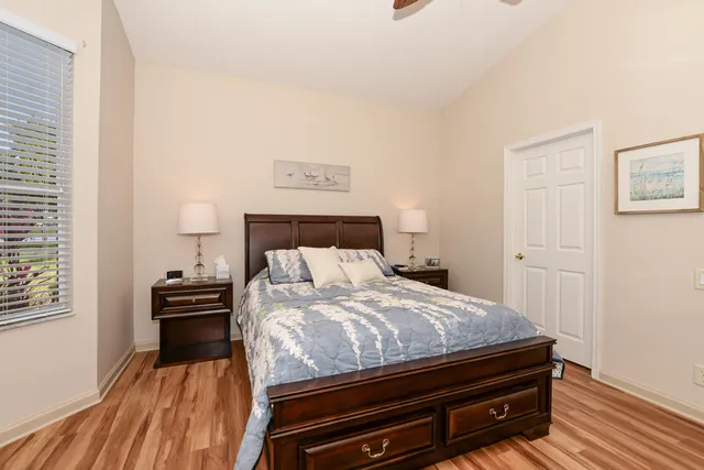a spacious bathroom with a double vanity sink a large mirror and a bathtub