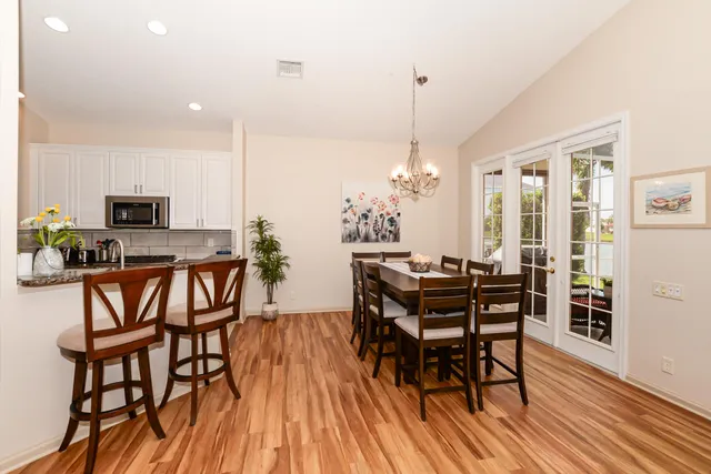 a kitchen with a sink refrigerator and cabinets