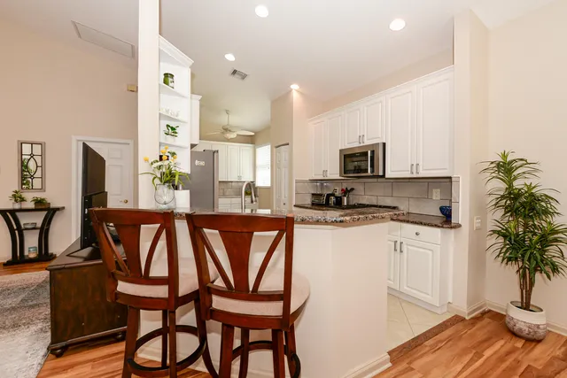 a kitchen with granite countertop a stove and a sink