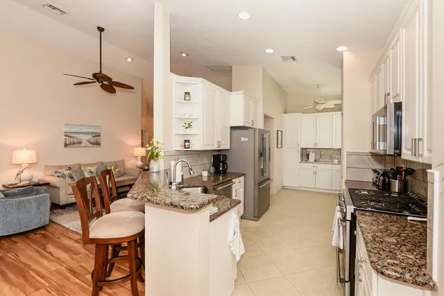 a kitchen with a sink cabinets and window