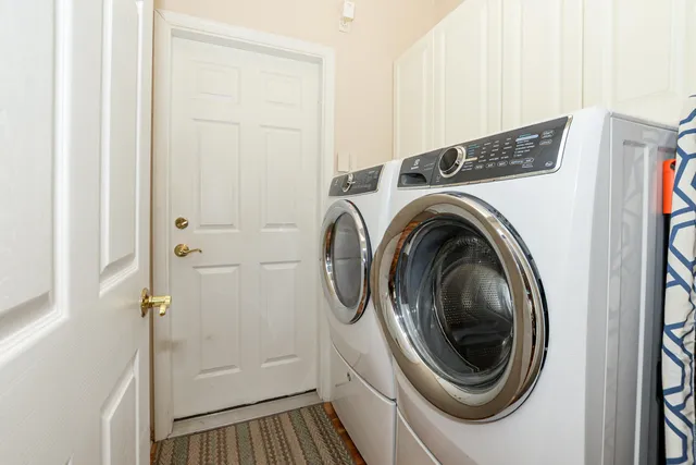 a view of a house with a swimming pool and palm trees