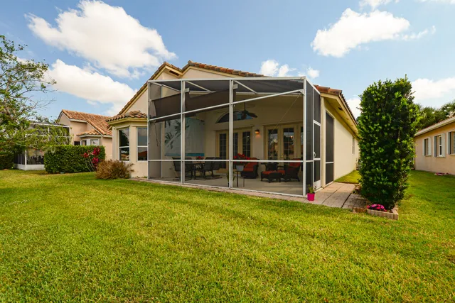 a view of a house with a backyard