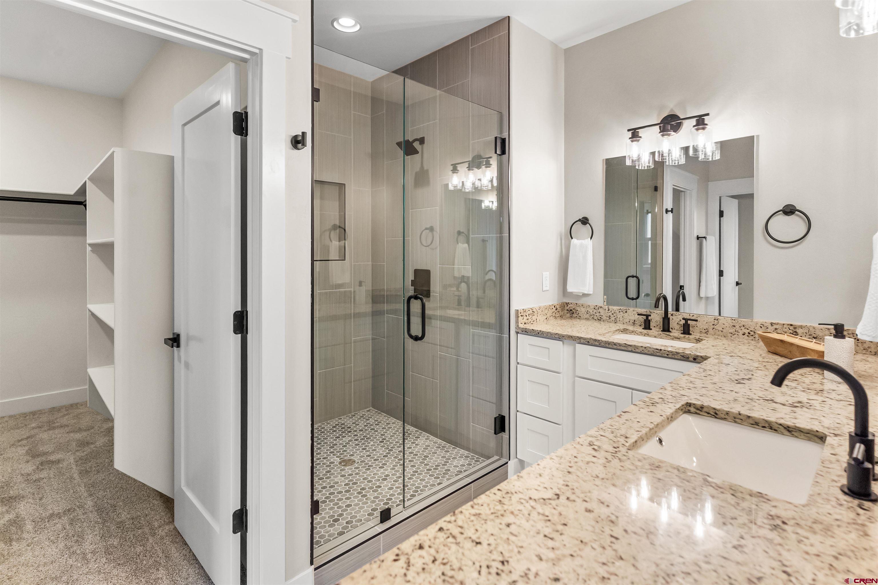 1533 Criterion Street Delta, CO 81416 - Photo 16 of 30 a bathroom with a tub sink and mirror