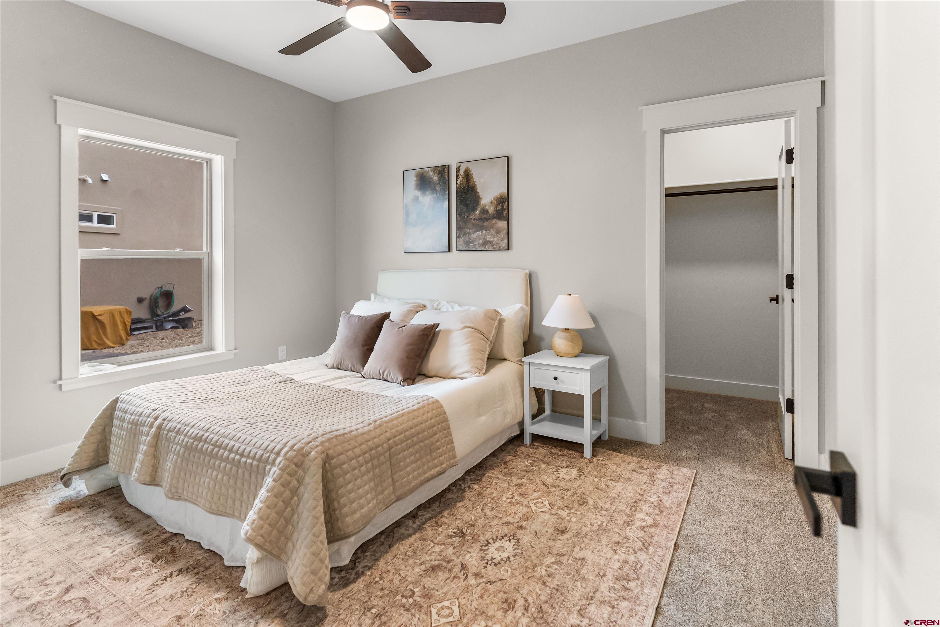 1533 Criterion Street Delta, CO 81416 - Photo 23 of 30 a bedroom with a bed and a painting on the wall