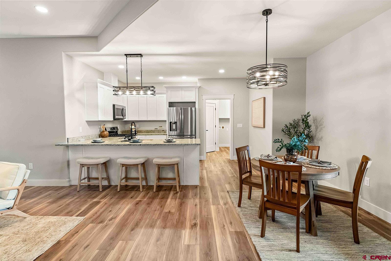 1533 Criterion Street Delta, CO 81416 - Photo 7 of 30 a view of a dining room with furniture and wooden floor