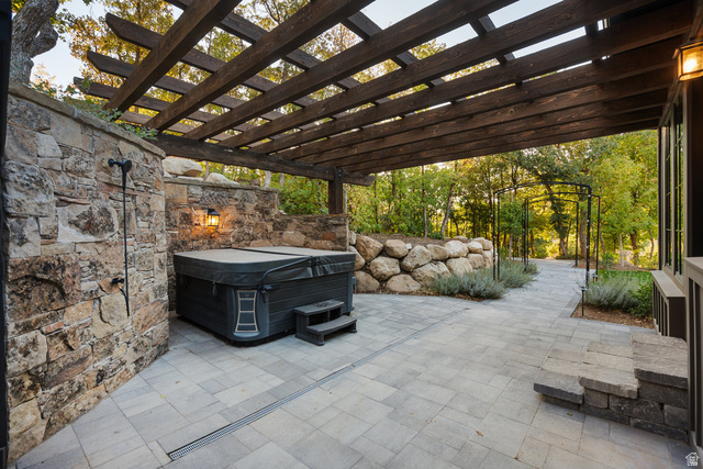 1141 South Oak Leaf Lane Springville, UT 84663 - Photo 116 of 147 Expansive stone paver patio featuring a hot tub and a dark wood pergola