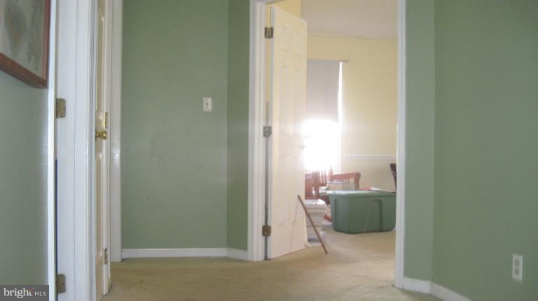 11316 Rawhide Road Lusby, MD 20657 - Photo 2 of 29 a room with a green cabinet and mirror