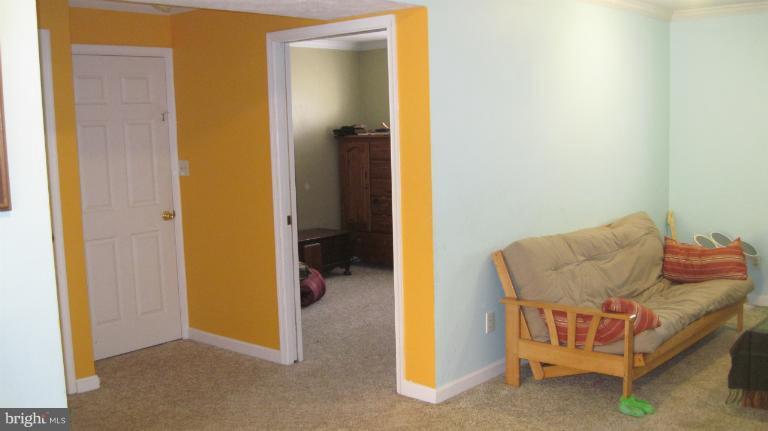 11316 Rawhide Road Lusby, MD 20657 - Photo 11 of 29 a living room with furniture and a gate