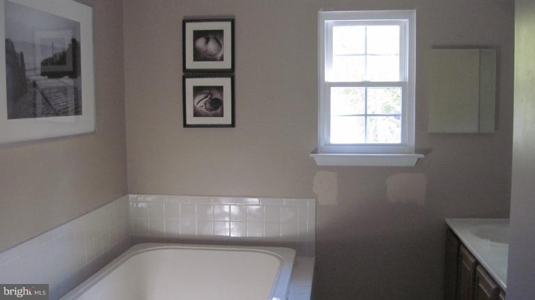 11316 Rawhide Road Lusby, MD 20657 - Photo 16 of 29 a bathroom with a bathtub