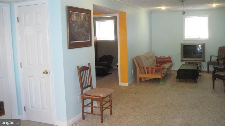 11316 Rawhide Road Lusby, MD 20657 - Photo 18 of 29 a living room with furniture a flat screen tv and a window