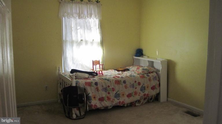 11316 Rawhide Road Lusby, MD 20657 - Photo 3 of 29 a bedroom with a bed and a window