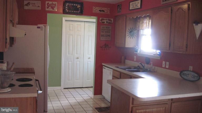 11316 Rawhide Road Lusby, MD 20657 - Photo 27 of 29 a kitchen that has a sink and a stove