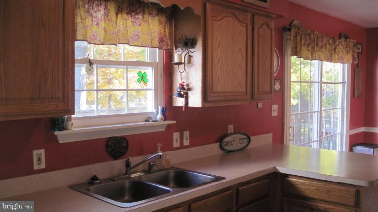 11316 Rawhide Road Lusby, MD 20657 - Photo 28 of 29 a kitchen with a sink and a window