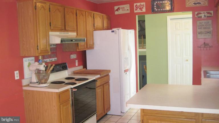 11316 Rawhide Road Lusby, MD 20657 - Photo 7 of 29 a kitchen with stainless steel appliances granite countertop a refrigerator and a stove
