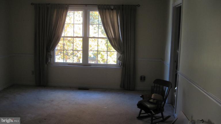 11316 Rawhide Road Lusby, MD 20657 - Photo 9 of 29 a room with windows and lounge chair