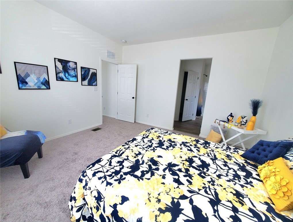 21621 Sandia Road, Unit 138 Apple Valley, CA 92308 - Photo 15 of 38 a bedroom with a bed and a dresser