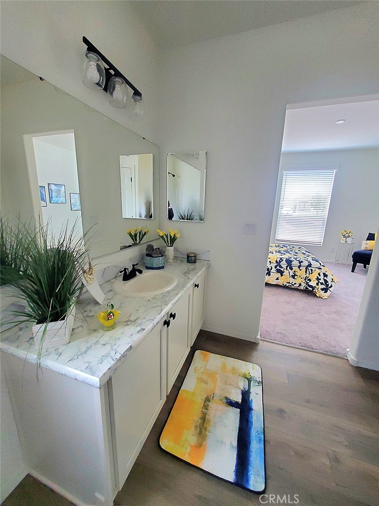 21621 Sandia Road, Unit 138 Apple Valley, CA 92308 - Photo 17 of 38 a bathroom with a sink a mirror and a bathtub